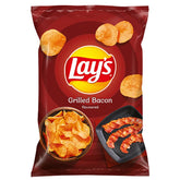 Lays - Grilled Bacon Crisps - 130g features crispy bacon-flavored snacks pictured with tempting chips and grilled bacon, delivering a savoury, guilt-free treat against a vibrant red backdrop.